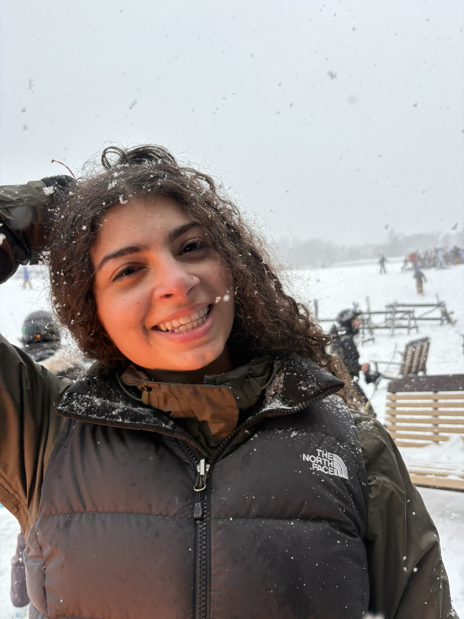 Carinne smiling during a snowy day outdoors